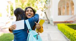 happy woman celebrates being accepted into college hugging mother